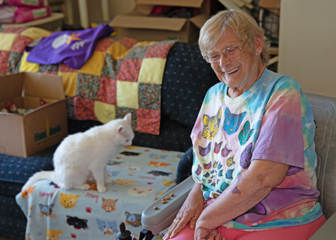 Smiling client sitting with her cat.